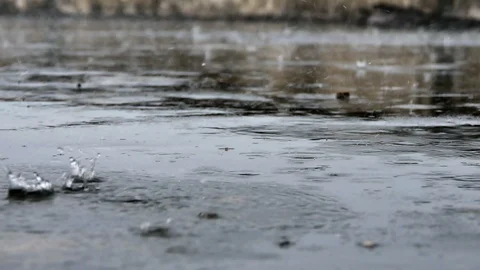 Raining droplets drop falling on ground of wet cements. Stock Footage 118241826