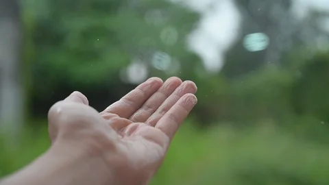 Raining drops of water flowing into the hands hd Slow 120 frames Video stock 120031491