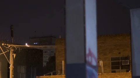 Raining in gritty city carpark buildings at night time Melbourne Stock Footage 101214091