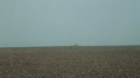 Raining. Modern tractor cultivating field's soil Video stock 62245862