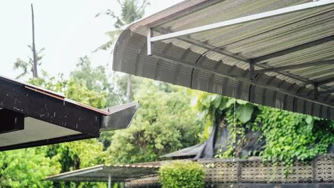 Raining on an old awning. Stock Photos