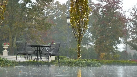 Raining outside table chairs framed light Video stock 120303482