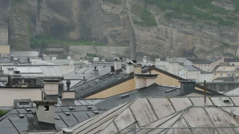 Raining over Salzburg's rooftops view from Kapuzinerberg Stock Footage 201500535