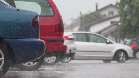 Raining, raindrops hit table, car parks in the rain, slow motion from 200fps Stock Footage 277789246