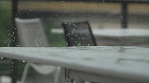 Raining, raindrops hit table, slow motion from 200fps footage Stock Footage 277136962