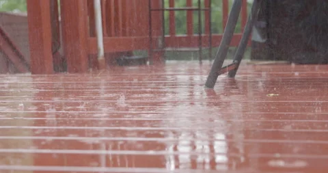 Raining on the red wood desk Stock Footage 131920981