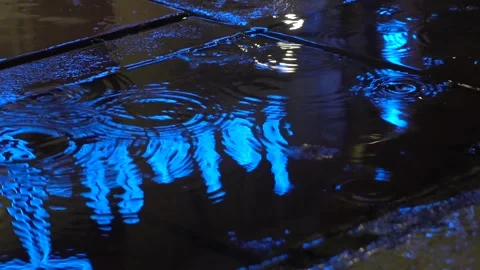 Raining ripples  with red blue neon light Stock Footage 295103797