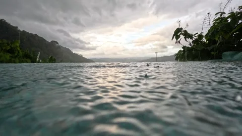 Raining view at infinity pool during sunset Stock Footage 257616823