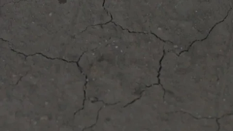 Raining water drops impacting cracked dry dirt in drought Stock Footage 71112150