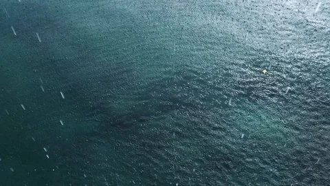 Raining on water surface, tropical rain in caribbean sea, monsoon season Stock Footage 107828152