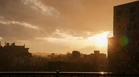 Raining while the sun is out in during sunset Stock Photos