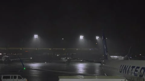 Rainstorm and lightning fall on a United Airlines 737 Max in Newark New Jers Stock Footage 241494896