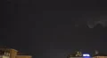Rainstorm in city, lightning bolts flicker over rooftops, rain and thunder sound HD Footage