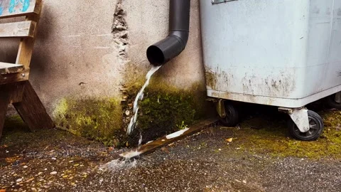 Rainwater Draining from Gutter Downpipe Stock Footage 331123743