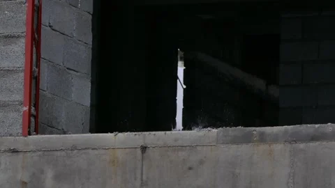 Rainwater dripping through wall gap and splashing on concrete Stock Footage 317826226