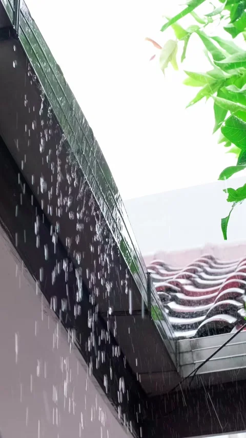 Rainwater drips from a roof gutter Stock Footage 346752104