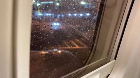 Rainwater drops in the plane window during the drizzle at night. Stock Footage 319404897