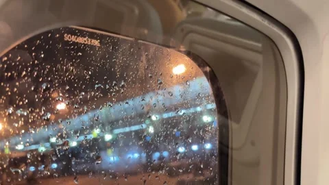 Rainwater drops in the plane window during the drizzle at night. Stock Footage 319404918