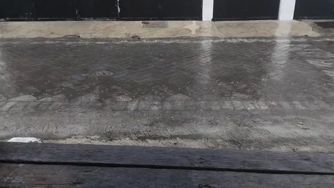 Rainwater falling on the paving blocks in the afternoon Stock Footage 285590129