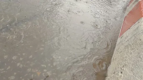 Rainwater flowing on the road Stock Footage 135364253