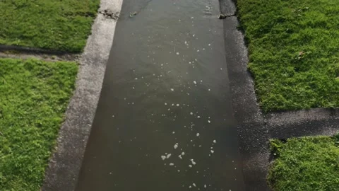 Rainwater flowing in a sewer under a drainpipe Video stock 174165276