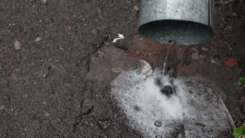 Rainwater flows from a chrome drain pipe close-up.  Stock Footage 287312672