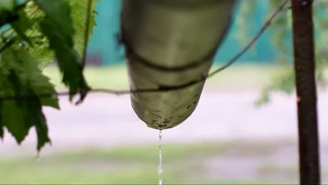 Rainwater flows down a drainpipe during warm summer rain. Stock-Footage 132261187