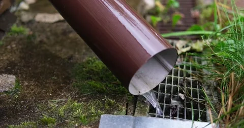 Rainwater flows down from the drainpipe. Stock Footage 138097094