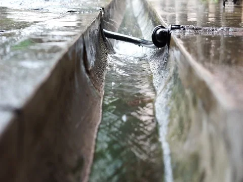 Rainwater flows in the drain. Selective focus Stock Footage 83963165