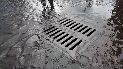 Rainwater flows into a grid Stock Footage 119585481