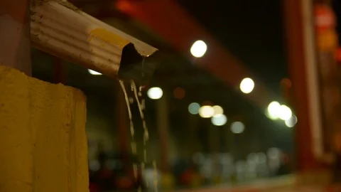 Rainwater flows out of the drainpipe night outdoor light 스톡 동영상 81588903