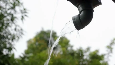 Rainwater flows out of a gutter Stock Footage 229078023