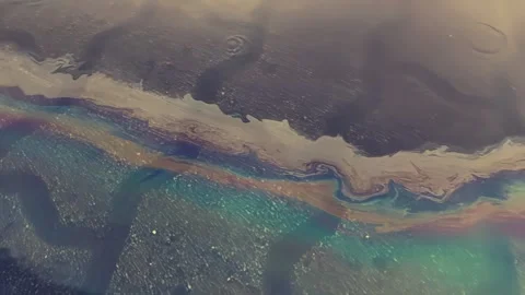 Rainwater Flows Over Paving Stones With Colors From Oil Film in Urban Area Stock Footage 345365135