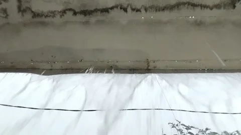 Rainwater overflows from the gutter due to heavy rain 動画素材 296473647