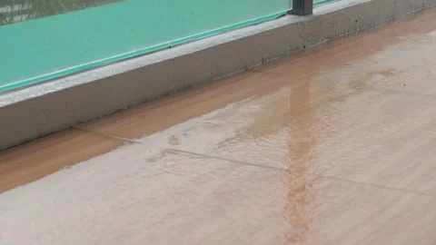 Rainwater Pooling on Modern Ceramic Balcony Tiles During Heavy Storm Stock Footage 339115552
