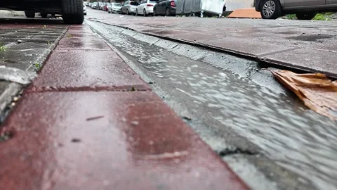 Rainwater Streaming Down a City Gutter in Istanbul Stock Footage 322618059