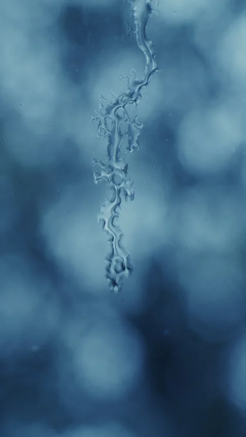 Rainwater streaming down window pane with bokeh background Stock Footage 321398314