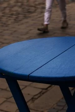 Rainy Blue Cafe Table with and Passing Figure Stock Photos