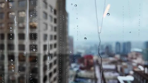 Rainy Cityscape View through a Window with Water Droplets Video stock 274465563