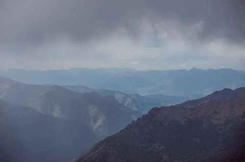 Rainy clouds against the backdrop of high mountains in the Altai Mountains Stock Photos
