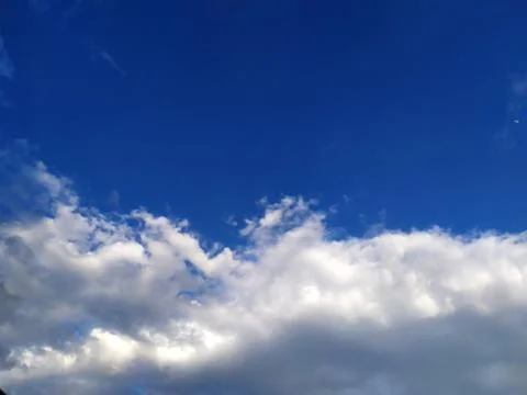 Rainy clouds flying in blue sky Stock Photos