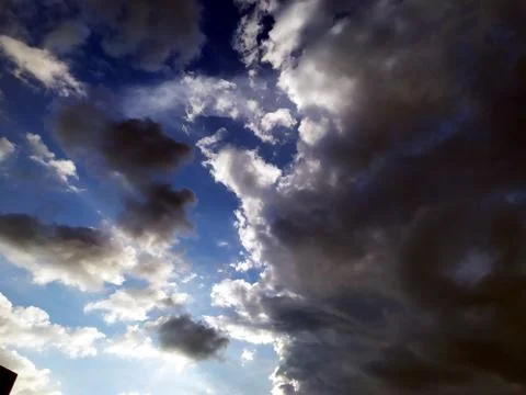 Rainy clouds flying in blue sky Stock Photos