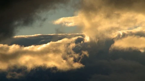 Rainy clouds lit at sunset Stockbeeldmateriaal 97715017