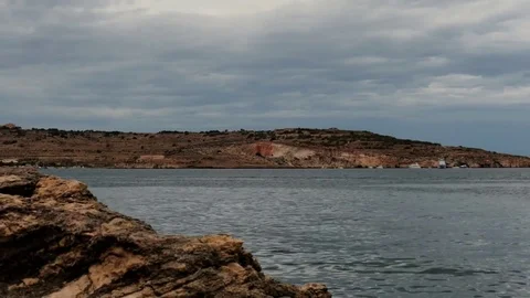 Rainy clouds in Malta landscape and minerals rock - zoom time lapse Stock Footage 76263171
