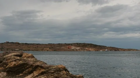 Rainy clouds at Maltese landscape and minerals rock - time lapse Stock Footage 63979769