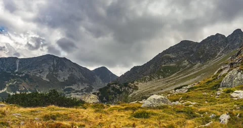 Rainy clouds motion fast over alps mountains in autumn landscape Stock Footage 292773392