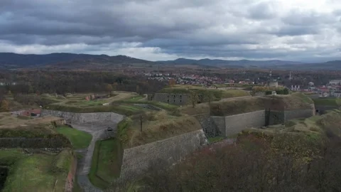 Rainy clouds moving over fortress, background with mountains range Sudetes Stock Footage 259406371