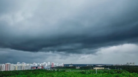 Rainy clouds sailing above a city Stock Footage 76688880