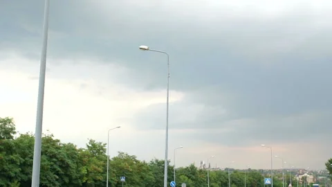 Rainy clouds in the sky over an empty road outside the city. Stock Footage 114977802