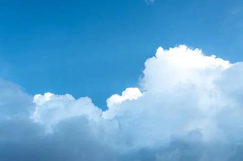 Rainy clouds transforming from white to dark and expanding on blue sky. Stock Photos